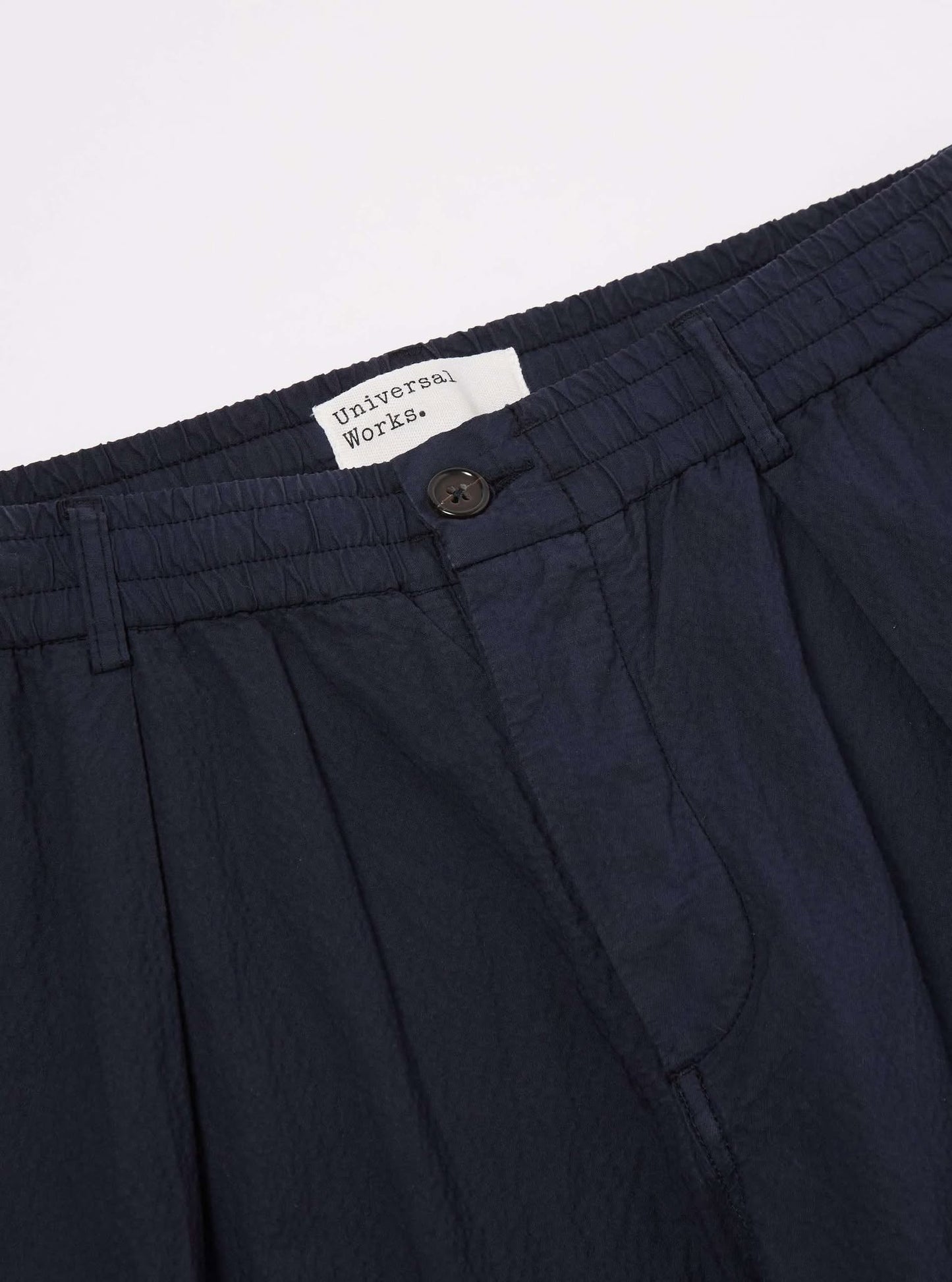 UNIVERSAL WORKS PLEATED TRACK PANT SEERSUCKER II - NAVY