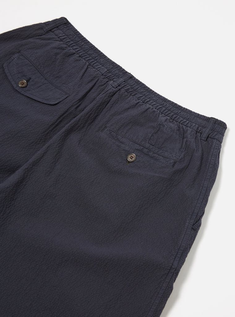 UNIVERSAL WORKS PLEATED TRACK SHORT II SEERSUCKER - NAVY